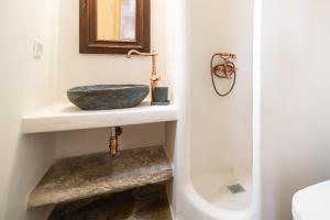 ein Badezimmer mit einem Spülbecken auf der Theke in der Unterkunft Iris villa in Koundouros
