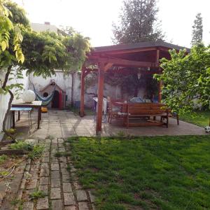 a pavilion with a picnic table and a bench at Pension Prislin in Litoměřice