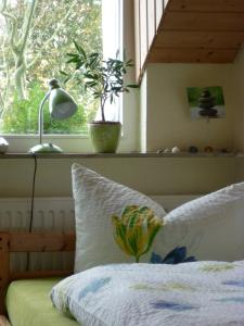 a bedroom with a bed with a lamp and a window at Bio Gesundheitshotel Haus Sonnenstein in Salem