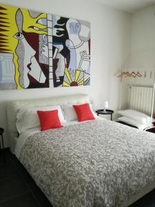 a bedroom with a bed with a painting on the wall at B&b My Bergamo in Bergamo