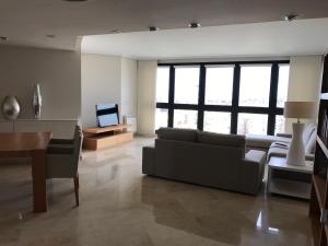 a living room with a couch and a television at apartamento ciudad de las ciencias in Valencia