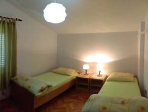 Postel nebo postele na pokoji v ubytování Apartments Silvija