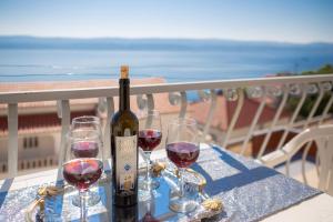een fles wijn zittend op een tafel met twee glazen bij FBA Family Beach Apartments in Omiš