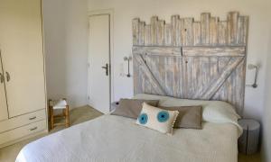 a bedroom with a bed with a large wooden door at Cycladic House in Naousa