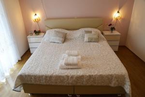 a bedroom with a bed with two towels on it at Apartments Anamarija in Makarska