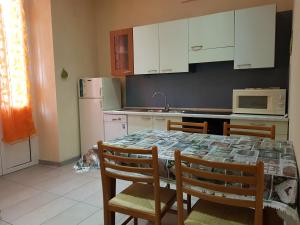 a kitchen with a table with chairs and a microwave at Casa Luciana in Savona