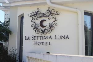 a sign for a la seimei luna hotel on a building at Hotel La Settima Luna in Savudrija