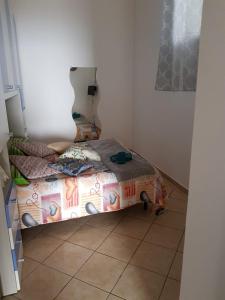 a small bedroom with a bed and a tiled floor at Villa Amalfi in Amalfi