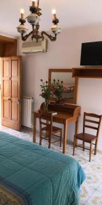 a bedroom with a desk and a table with a tableablish at Villaggio "Camping Pompei" in Pompei