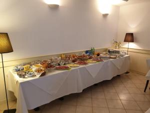 a long table with a buffet of food on it at Hotel La Settima Luna in Savudrija