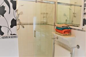 a shower in a bathroom with a glass shower backdoor at Telford House in Milton Keynes