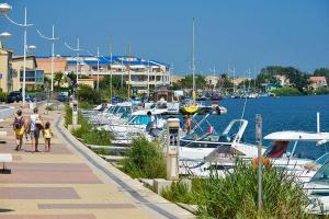 a group of boats are docked in a marina at La belle étape in Sérignan