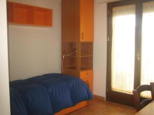 a bedroom with a bed and a book shelf and a window at "Za' Vittoria" in Bomba