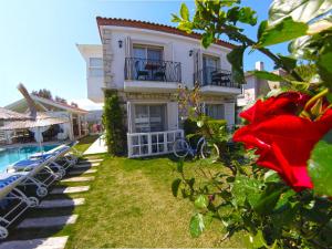 a house with a swimming pool next to a building at Morisi Konak Butik Otel in Alacati