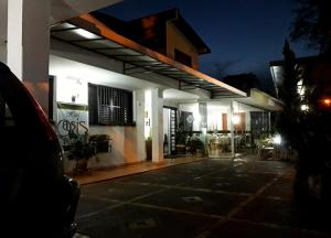 a lit up gas station at night at Hotel Pousada Oasis Park in Jaboticabal