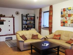 a living room with two couches and a coffee table at Ferienhaus Tettenweis in Tettenweis