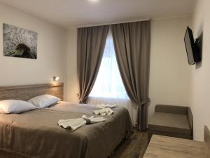 Postel nebo postele na pokoji v ubytování Hotel Bonus + 33 fotografií