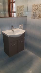 a bathroom with a sink and a mirror at Serenella Apartament in San Vito lo Capo