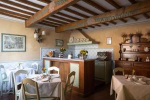a dining room with two tables and a kitchen at B&B Le Cannelle FIESOLE in Fiesole
