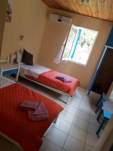 Postel nebo postele na pokoji v ubytování Hotel Neos Matala