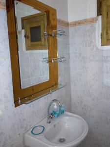 a bathroom with a sink and a mirror at Chez Coumba et Daniel in Saly Portudal +38 photos