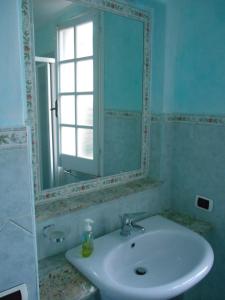 a bathroom with a sink and a mirror at Villa Annina B&B in Tropea