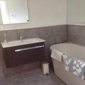 a bathroom with a sink and a bath tub at Estuary View Farm in Kingsbridge