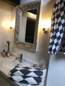 a bathroom sink with a mirror and a towel on it at Atelier Kurt in Hinterbrühl +5 photos