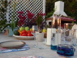 una mesa con platos, vasos y fruta. en Palmina Mare Villa and Studios en Paralia Vrachou
