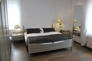 a bedroom with a large bed and a mirror at Hotel Goldener Stern in Ascheberg