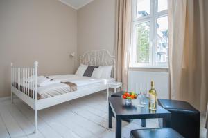 Posteľ alebo postele v izbe v ubytovaní Riviera Residence Apartments