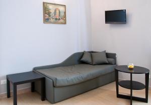 a living room with a couch and a tv at Operà in Palermo