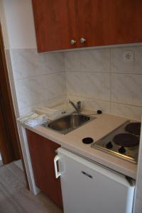 a small kitchen with a sink and a stove at Apartments Šarić in Baška Voda +46 photos