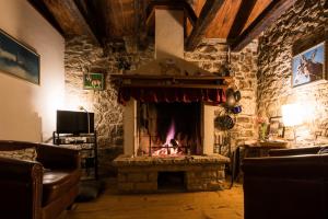 a living room with a fireplace in a stone wall at Summerhouse Beram in Pazin