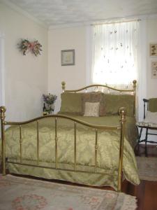 a bedroom with a bed in a room with a window at Historic Hill Inn in Newport