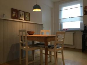 a dining room table with two chairs and a window at Wohlfühlambiente in Dorsten in Dorsten