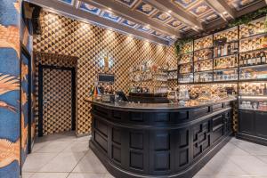 a bar in a room with a wall of wine bottles at Benso Rooms in La Spezia
