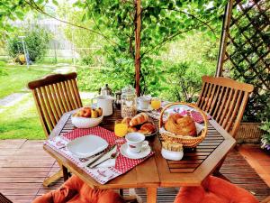 a wooden table with a breakfast of bread and eggs at B&B Nautilus in Puegnago