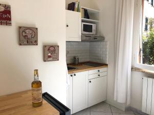 a kitchen with a bottle of wine sitting on a table at Soggiorno Tagliaferro in Marciana Marina