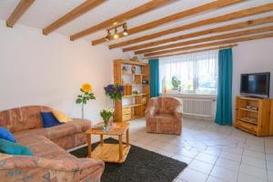 a living room with two couches and a tv at Ferienwohnung Gross A in Schleiden