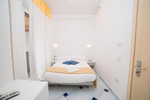 Postel nebo postele na pokoji v ubytování Hotel De Rosa