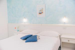 Postel nebo postele na pokoji v ubytování Hotel De Rosa