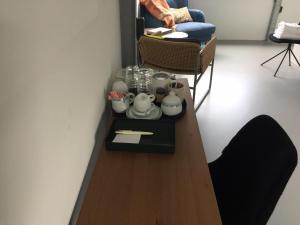 a table in a room with a chair and a table with tea pots at Reiwa in Amsterdam