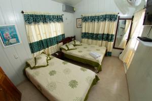 Giường trong phòng chung tại Posada Nativa Atardecer Isleño