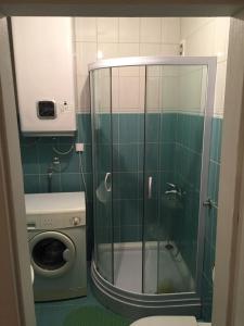 a bathroom with a shower and a washing machine at Villa Palma Ceoce in Budva +42 photos