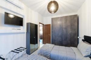 a bedroom with a bed and a tv on a wall at Appartamento moderno San Siro in Milan