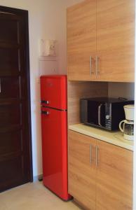 a kitchen with a refrigerator, stove and microwave at le relais de tiuccia in Casaglione