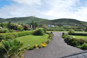 a walkway through a garden with mountains in the background at Cúl Draíochta B&B in Cahersiveen