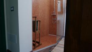 a bathroom with a shower with a glass door at Iter Greenhouse in Verona