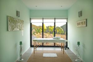 a room with a table in front of a window at A.TI.TUDO Nature in Portimão